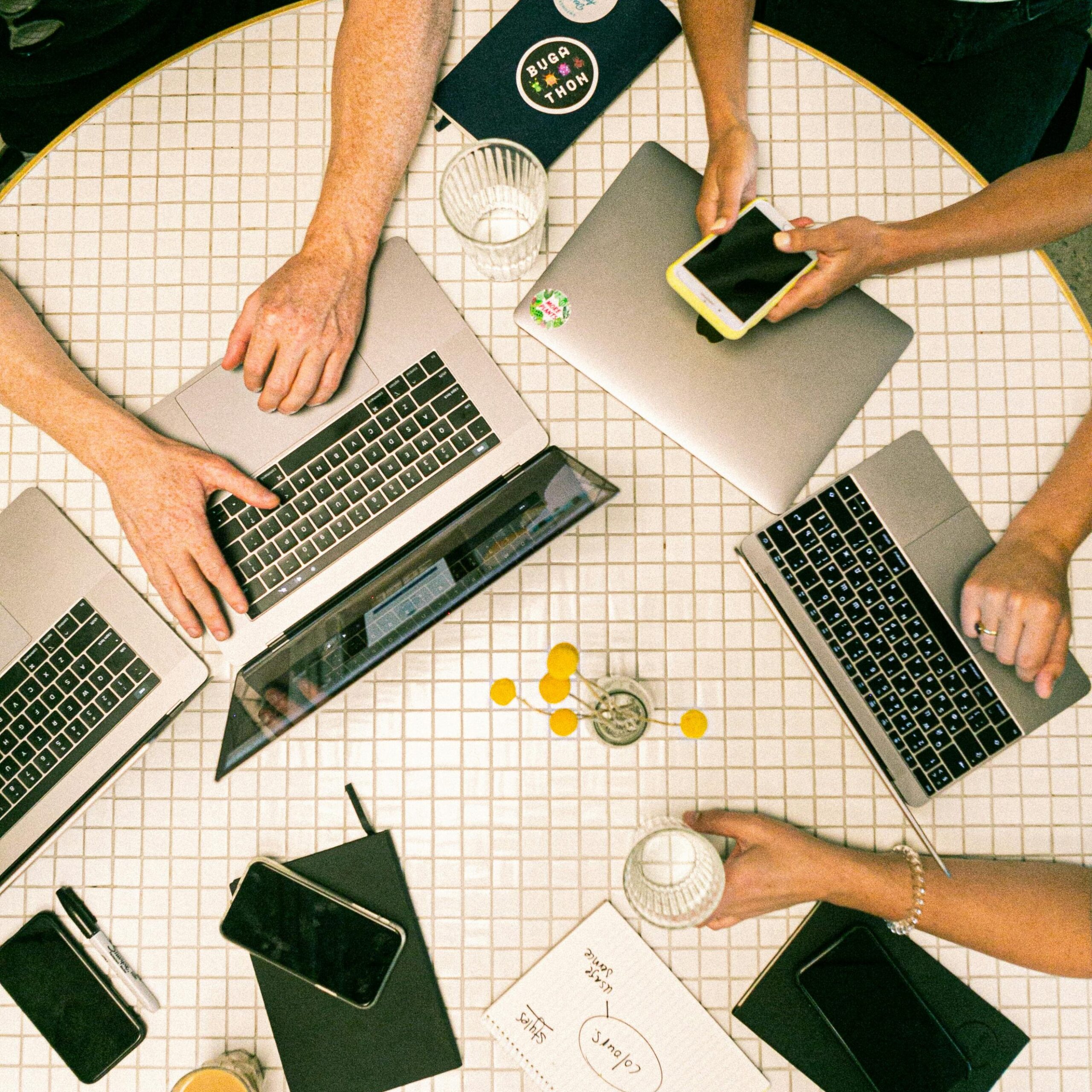 A group of people working on their laptops in a caffee.